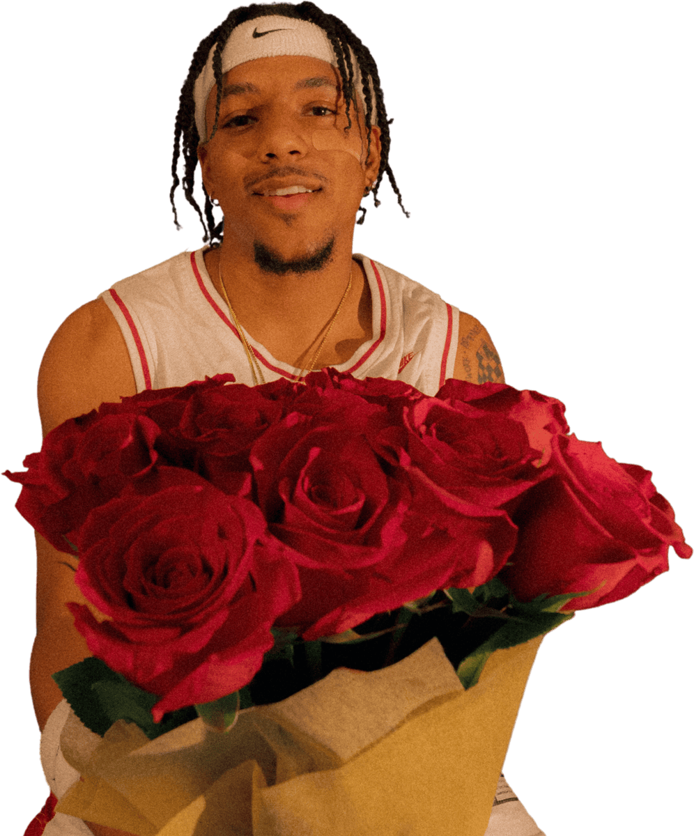 Leo Rain holding a bouquet of red roses